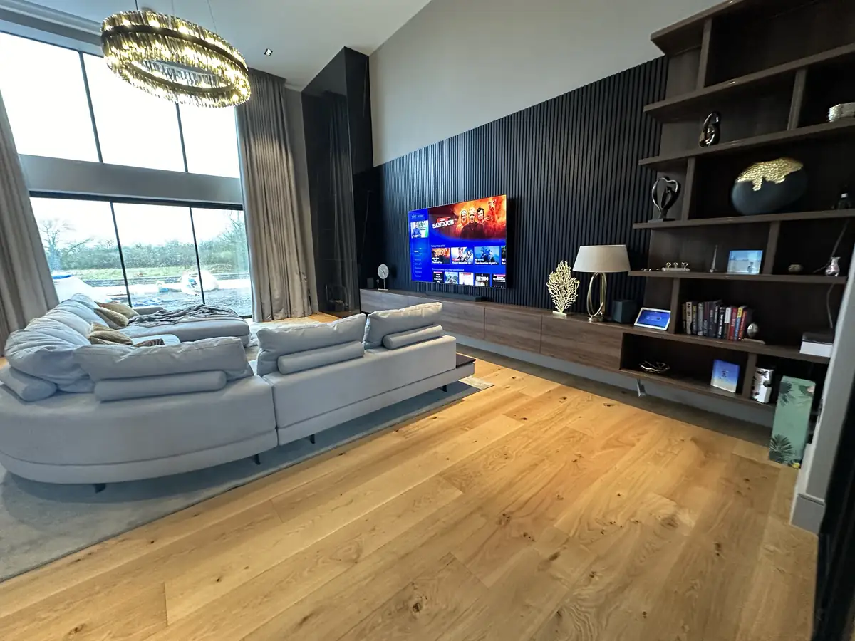 Living room with a double height ceiling, TV and built in sound system